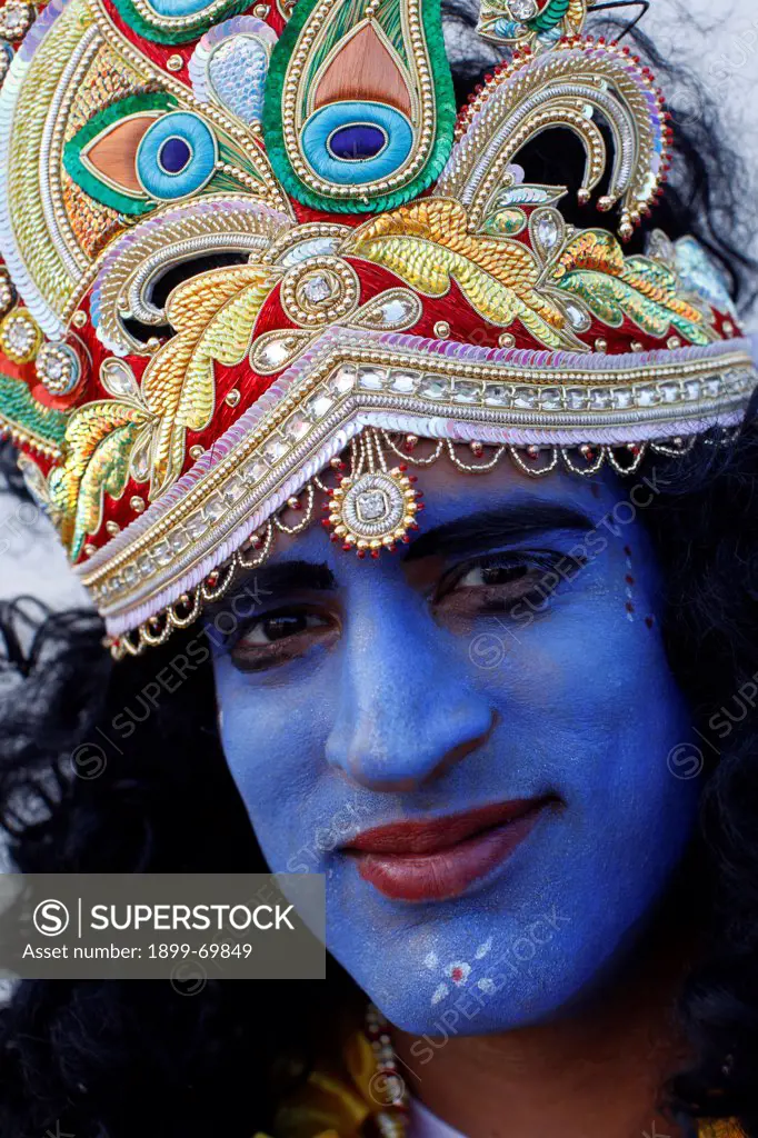 Man impersonating Hindu god Krishna at Janmashtami festival at Bhaktivedanta Manor ISKCON (Hare Krishna) temple