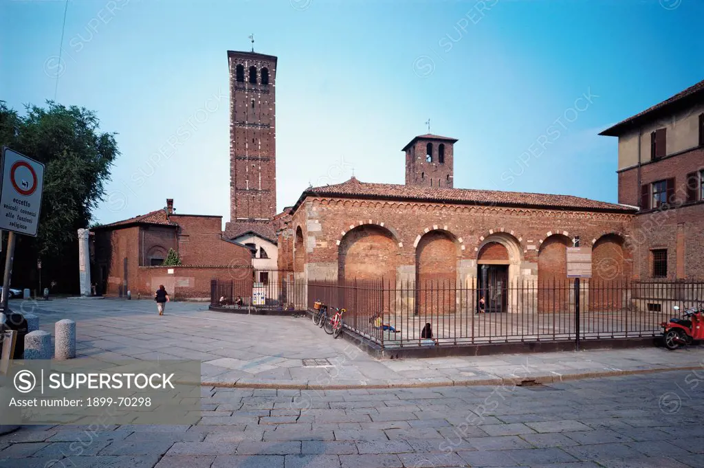 Italy, Lombardy, Milan, Basilica of St. Ambrose. External view showing the entrance side, the gate, the bell towers and the false arches.