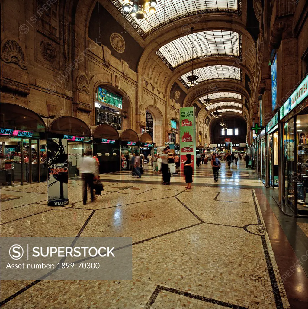 Italy, Lombardy, Milan. Internal view of the Central Train Station showing a gallery with glass roof lights and geometrical decorated floor.