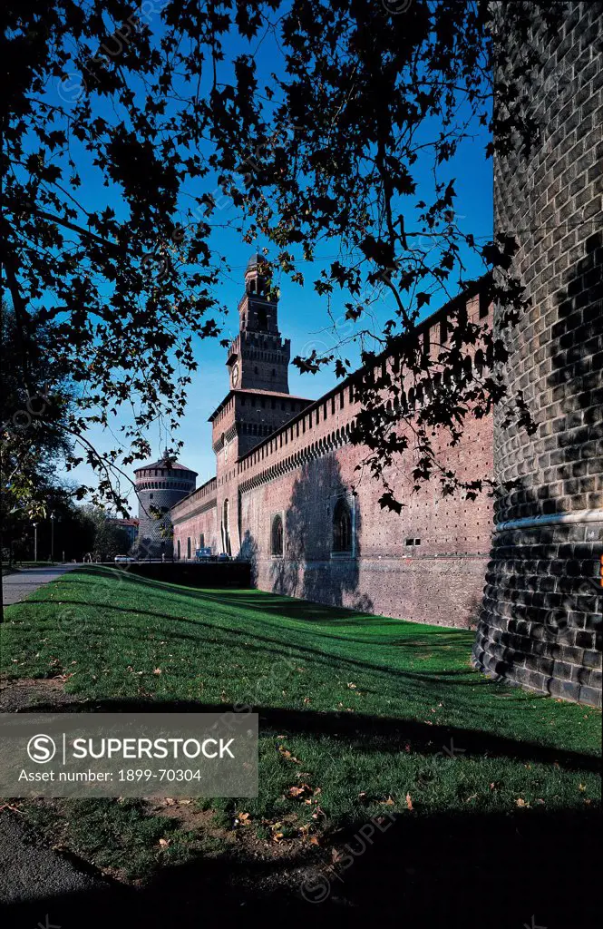Italy, Lombardy, Milan, Sforza Castle. View of the Sforza Castle external walls and the Filarete tower. The adjoining garden is also visible.