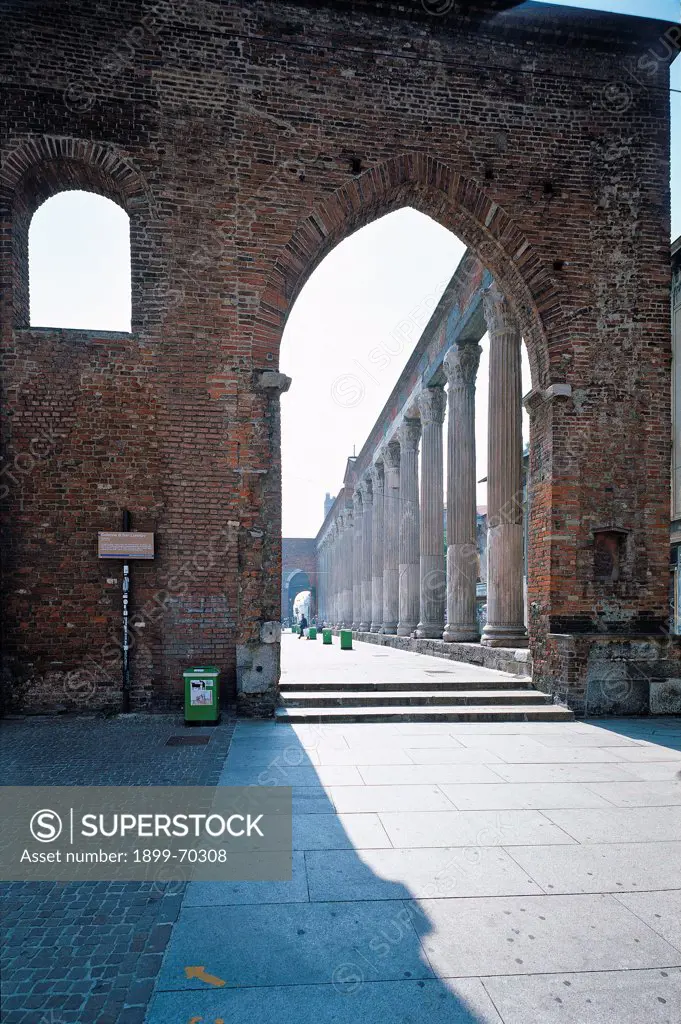 Italy, Lombardy, Milan. Detail. External view of the Basilica, with an arch and the columns that delimit the inner square.