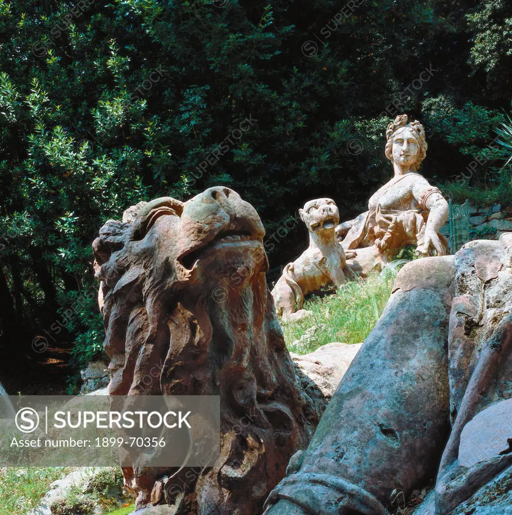 Italy, Tuscany, Collodi-Pescia (Pistoia), Giardino storico e Villa Garzoni. Detail. View of the statue that depicts Lucca with a panther; in the foreground the sculpture of the lion that accompanies the one of Florence.