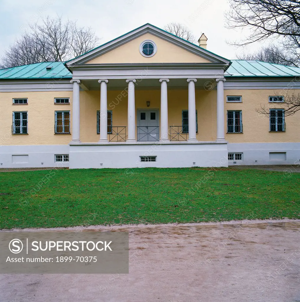 Germany, Munich, Englischer Garten. Detail. Front view of the Palladian building that presents a colonnade with Ionic columns, pediment, tympanum, portico and pronaos.