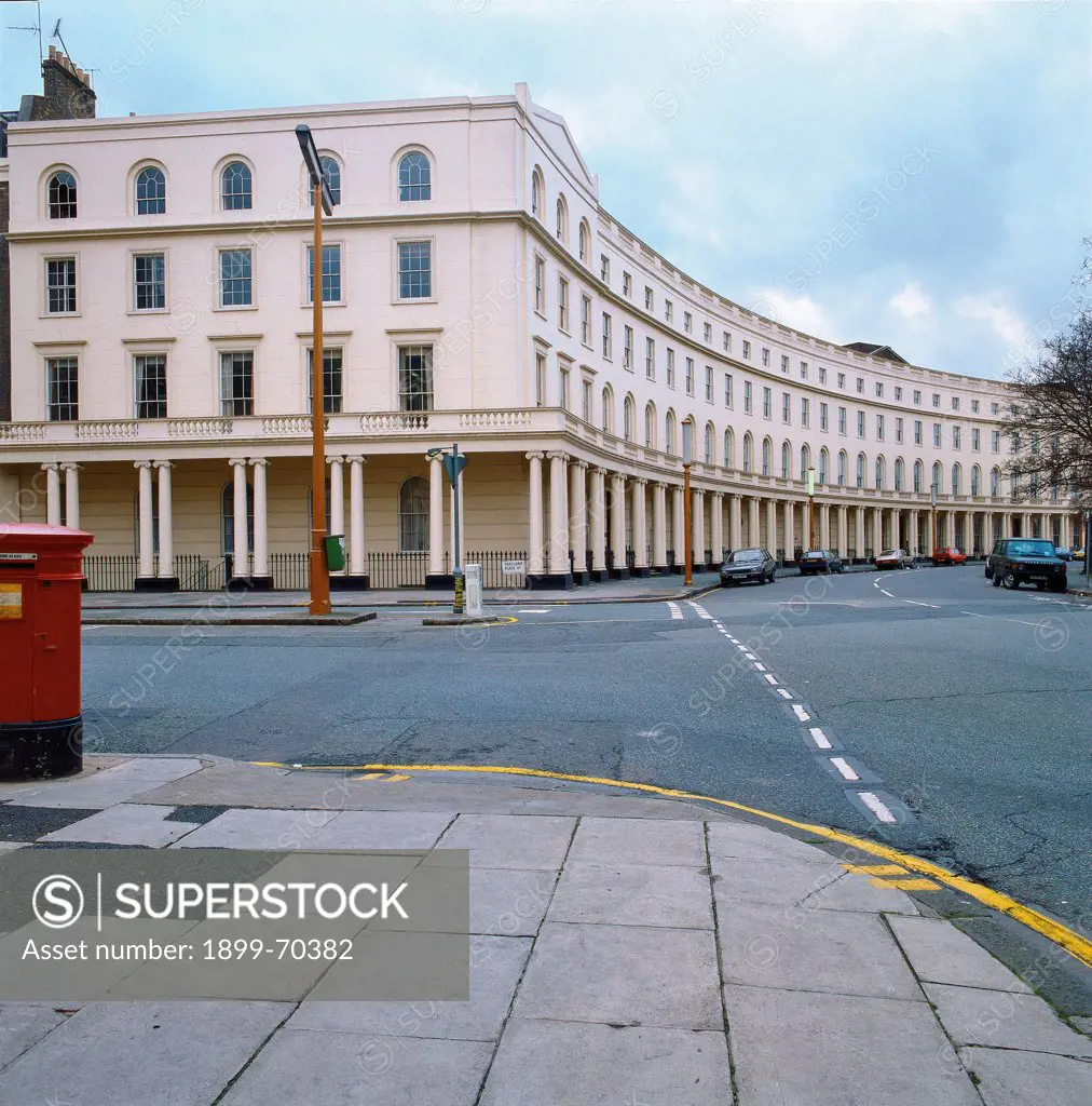 United Kingdom, London, Regent's Park. Detail. Foreshortened view of Crescents buildings with coupled columns, windows and convex facade, in front of a street.