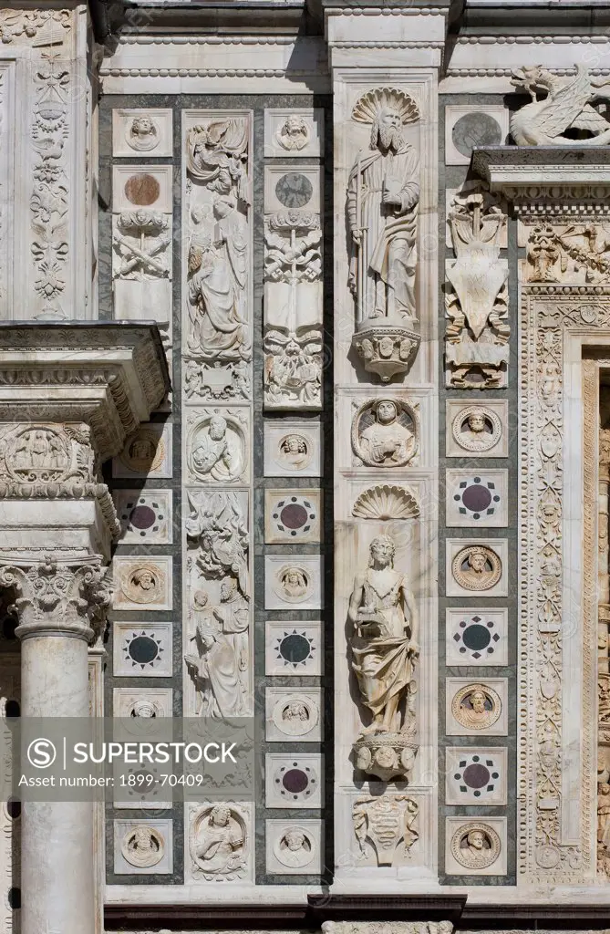 Italy, Lombardy, Pavia, Carthusian monastery. Detail. Detail of the monastery front, showing a column, squares with polychrome marble inlays and bas-reliefs and a few statues.