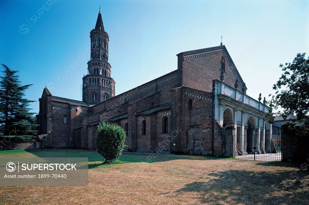 Italy, Lombardy, Milan. Whole artwork view. View of the Cistercian abbey that presents an octagonal bell tower, two-light windows, Lombard bands, buttresses. Foreshortening of the facade with the portico.