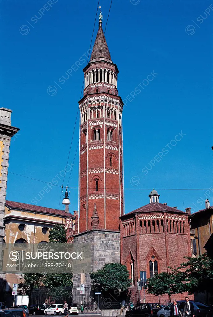 Italy, Lombardy, Milan. Whole artwork view. View of the octagonal bell tower made of bricks with two-lights windows, little columns and little arches.