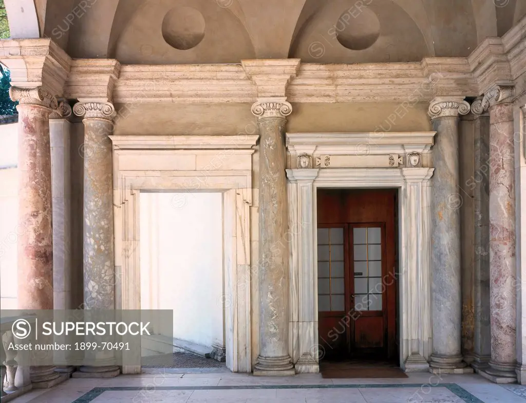 Italy, Lazio, Rome (Rome), Villa Giulia. Detail. In the nympheum of the villa, front view of the portico with columns, cornice and a door.