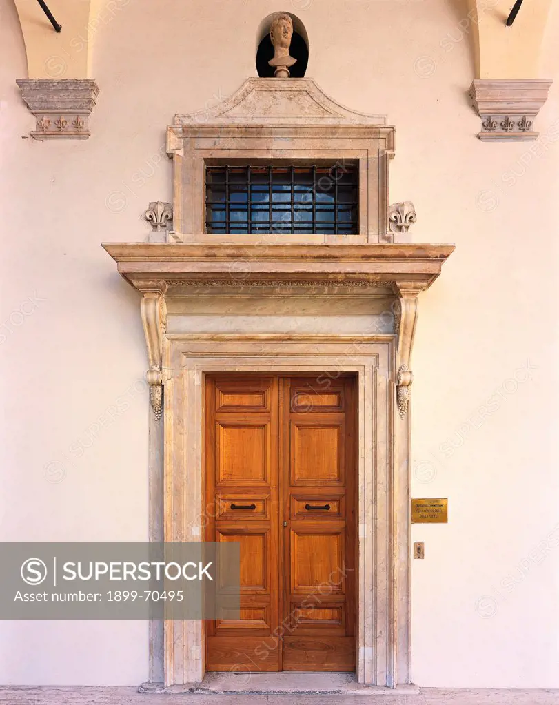 Italy, Lazio, Rome (Rome), Palace of the Chancellery. Whole artwork view. Front view of the portal with opening in a ratio of 1:2, a convex-concave frieze, an architrave resting on volute corbels.