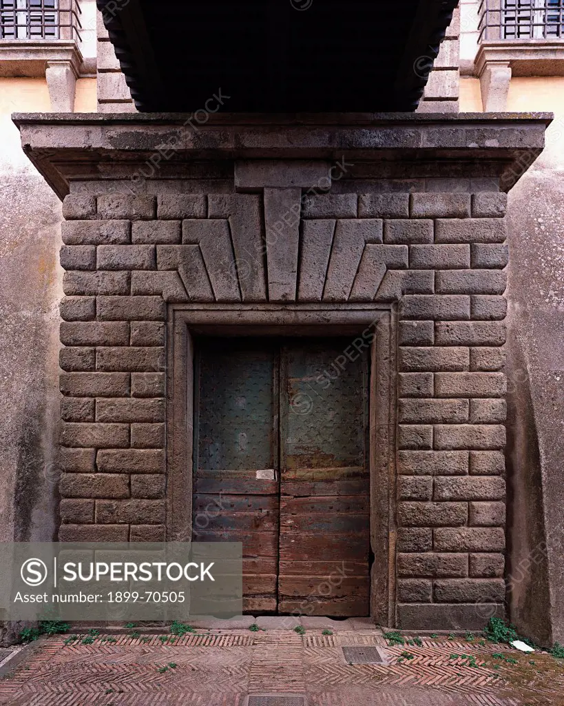 Italy, Lazio, Caprarola (Viterbo), Villa Farnese. Detail. Front view of the entrance to the cellars, whose door is framed by rustication.