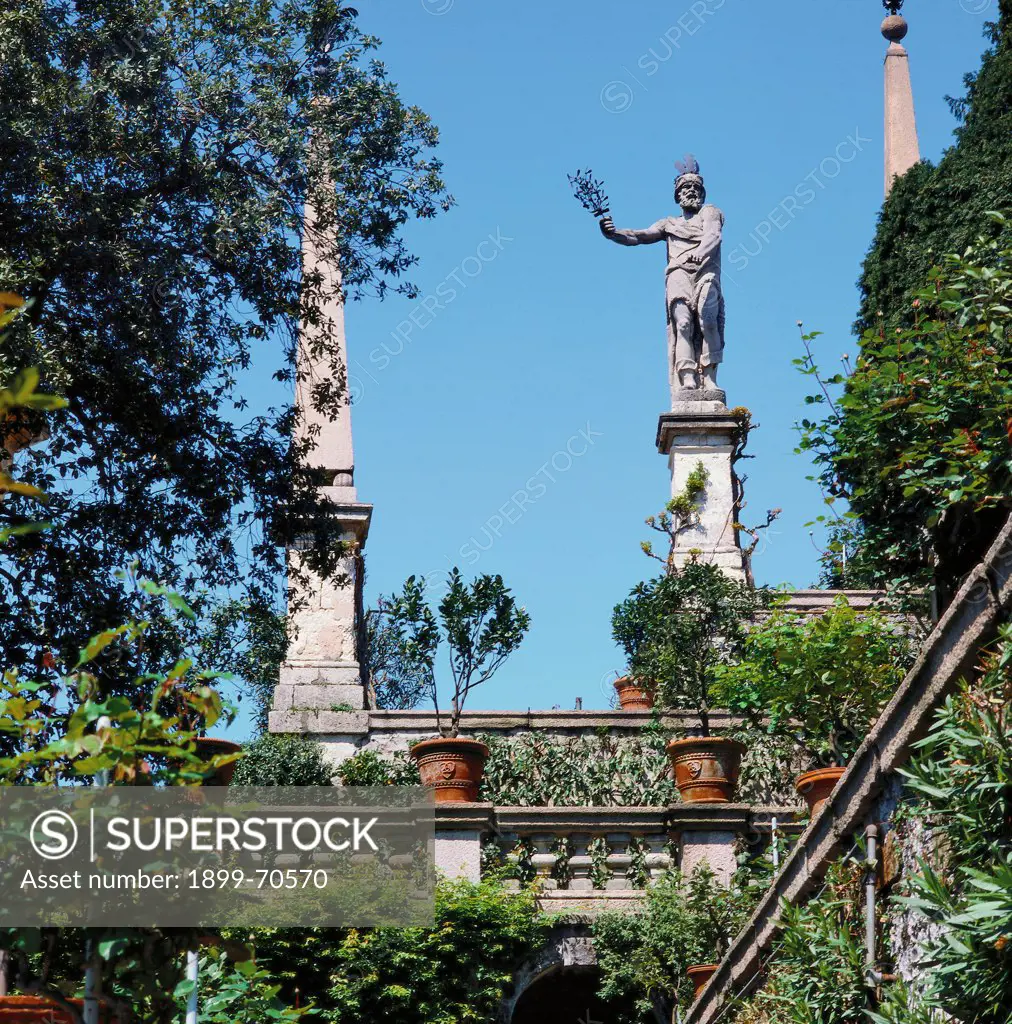 Italy, Lombardy, Isola Bella, Borromeo Gardens. View from below. A terrace adorned with obelisks and an allegorical sculpture.