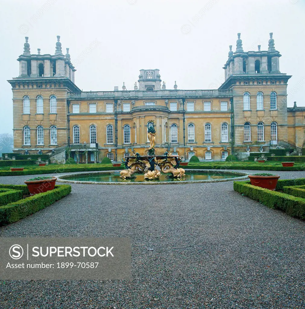 United Kingdom, Oxfordshire, Woodstock, Blenheim Palace. Detail. Foreshortening view of the Italian gardens with a fountain in the middle and the palace as background.