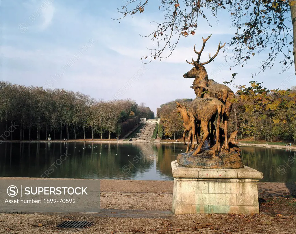 France, Sceaux, Sceaux Castle (Chateau de Sceaux). Detail. A fountain of the garden. In the foreground a sculpture with deers, in the background a terraced waterfall.