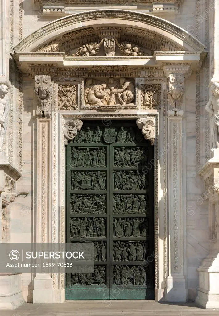 Italy, Lombardy, Milan, Duomo, First portal from right. Whole artwork view. The portal with the Stories of the Cathedral and the high relief on the tympanum.