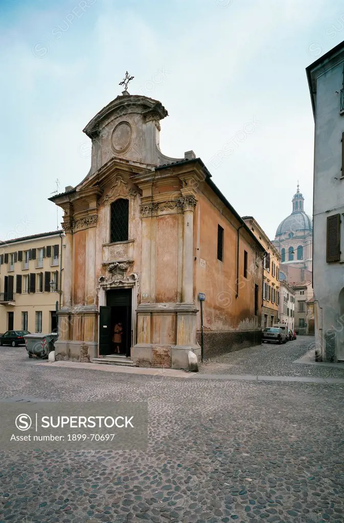 Italy, Lombardy, Mantua, Canossa Square. Whole artwork view. A foreshortening view of the baroque facade of the church of Our Lady of the Earthquake decorated with pilasters and surmounted by a curvilinear pediment.