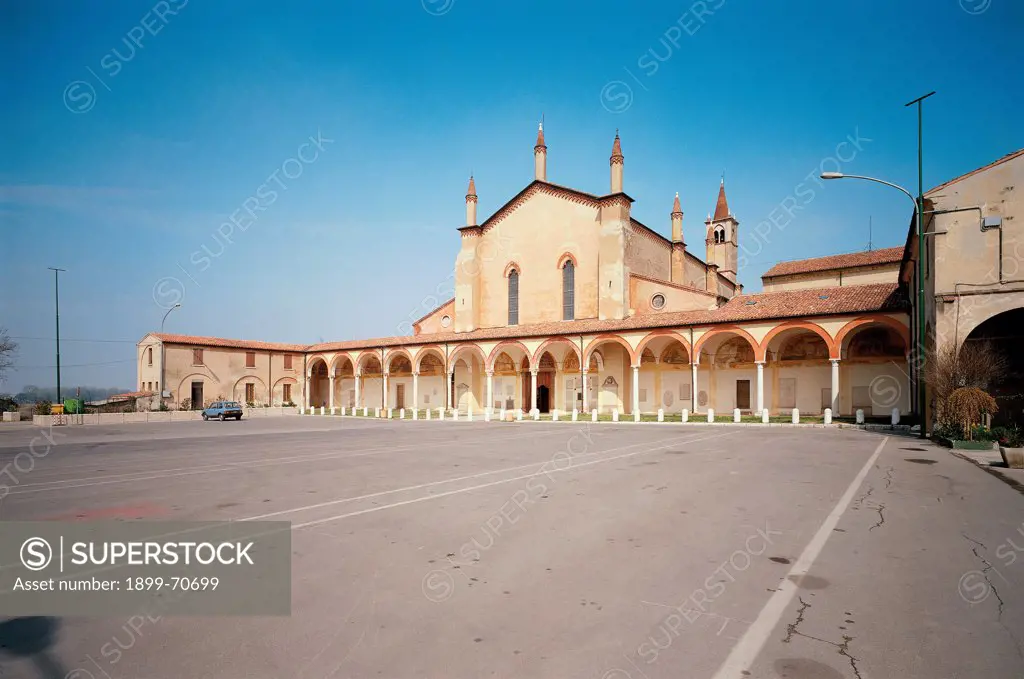 Italy, Lombardy, Curtatone, Santuario Square. Whole artwork view. The long porch of the shrine and its facade surmounted by pinnacles seen from the square in front of it.