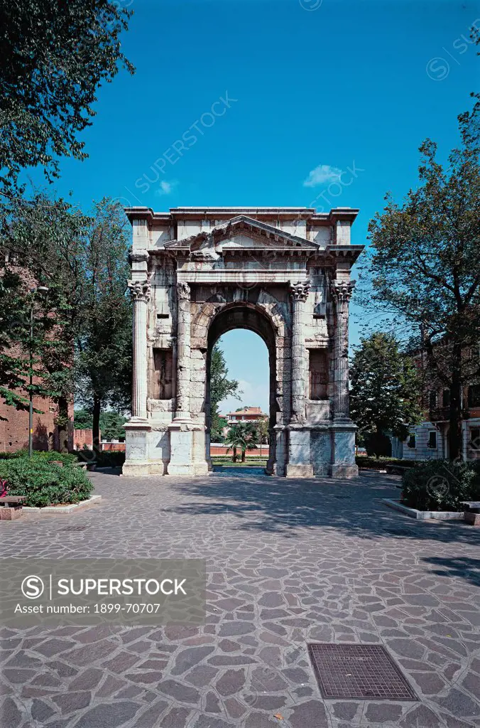 Italy, Veneto, Verona, Corso Castelvecchio. Whole artwork view. Overview of the Arch of Gavi among the vegetation. Next to the central arch are placed four columns and between them some niches.