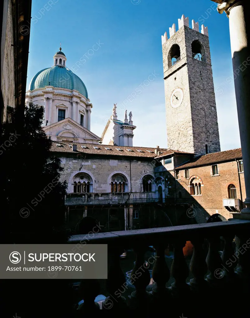 Italy, Lombardy, Brescia, Prefecture Palace. Detail. The civic tower (Torre del Popolo) and the Cathedral dome seen from the inner courtyard of the medieval flank of the Palace of the Prefecture, formerly Broletto.