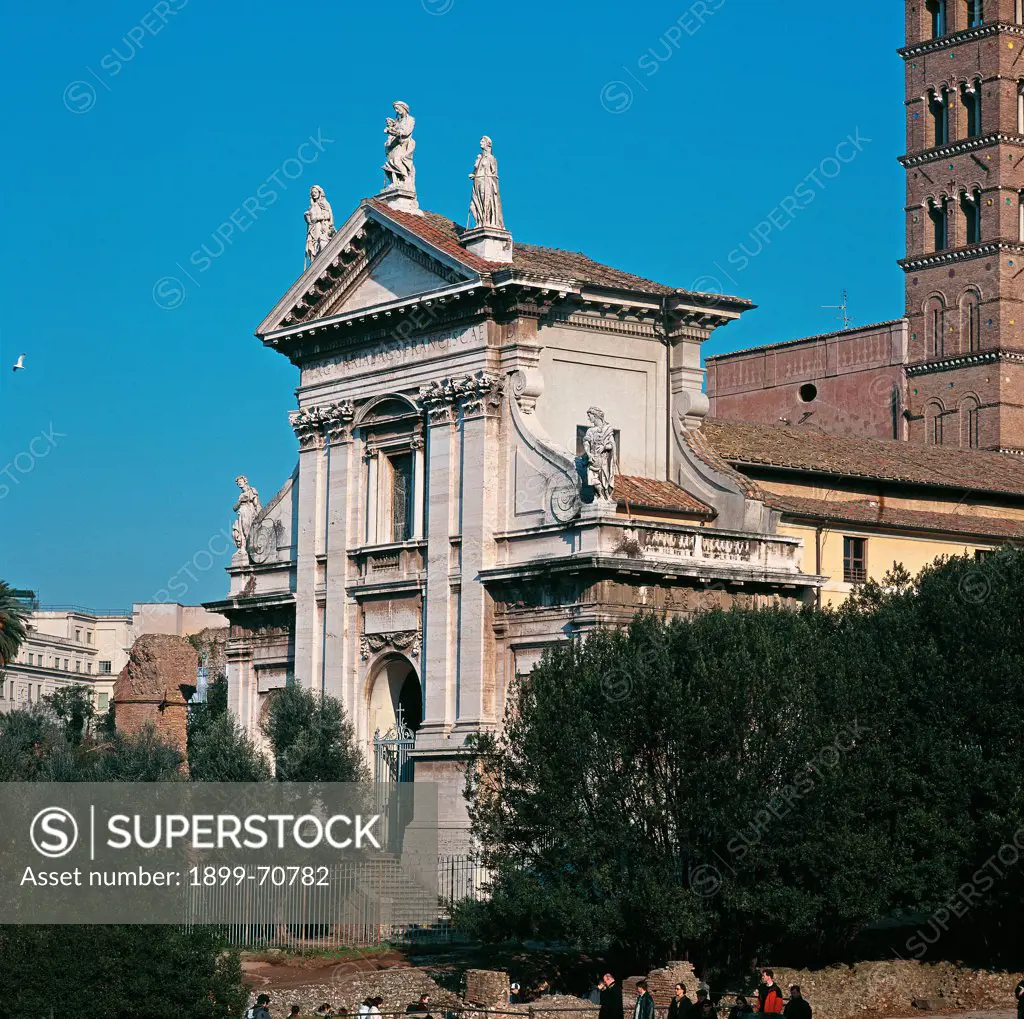 Italy, Lazio, Rome, Church of Saint Francesca Romana. Detail. A foreshortening view of the facade marked out by a triangular pediment surmounted by three statues on the top and by a porch in the basement.