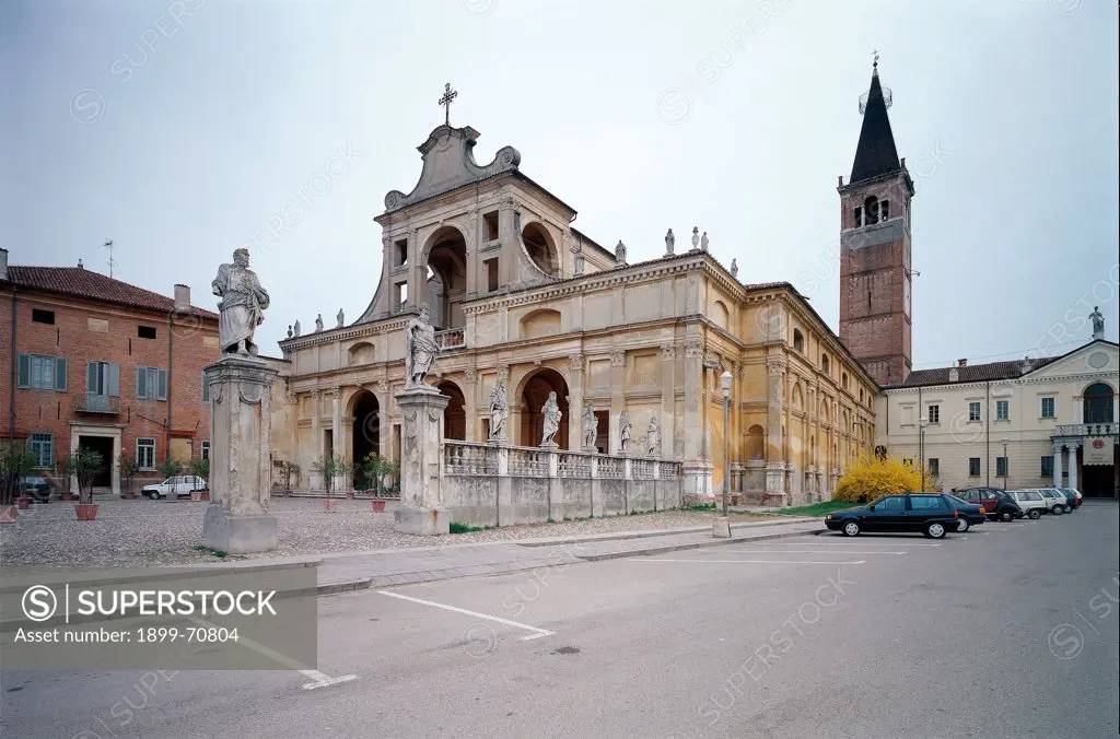 Italy, San Benedetto Po, Mantova, Polirone Abbey. Whole artwork view. The fornices and arches of the facade of the abbey church, with the tower bell on the background.