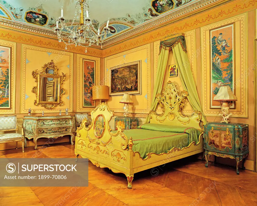 Italy, Piedmont, Chivasso, Villa Cimena. Detail. View of the bedroom with parquet, the walls host japanese paintings and the ceiling is frescoed; the furnishing includes two painted nightstand and an also painted console.