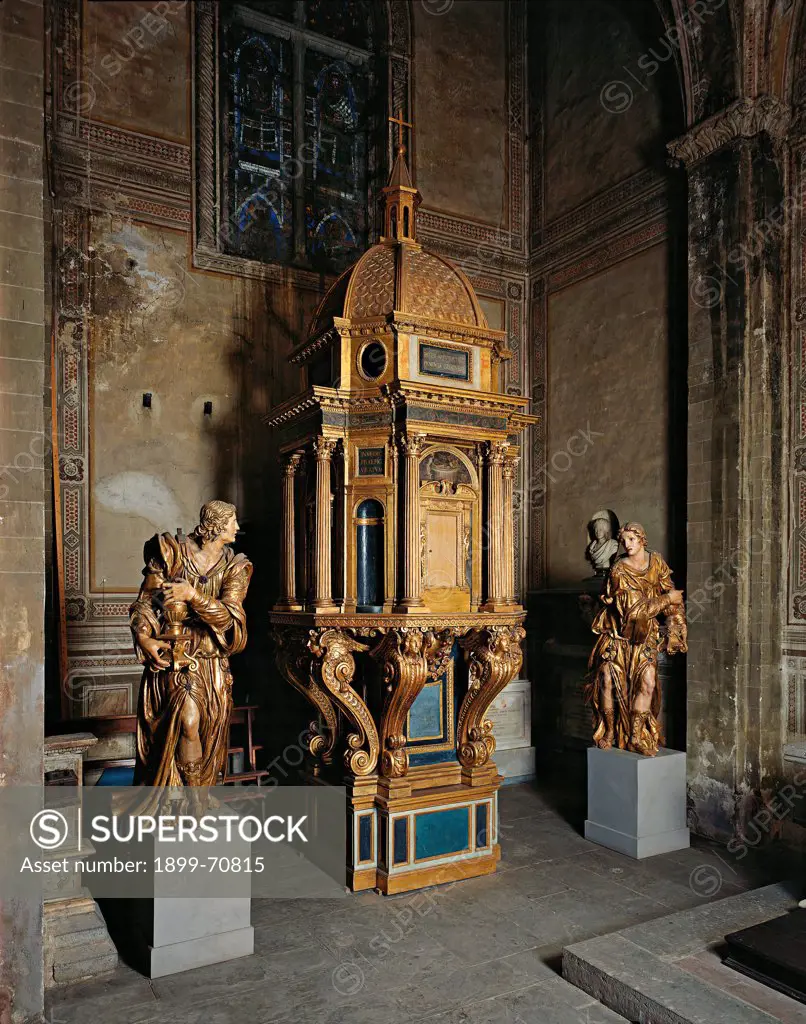 Italy, Tuscany, Florence, Basilica of Santa Croce. Whole artwork view. The wooden ciborium composed of a central plan temple with a dome, supported by baroque volutes, between two angels holding vases with flames.