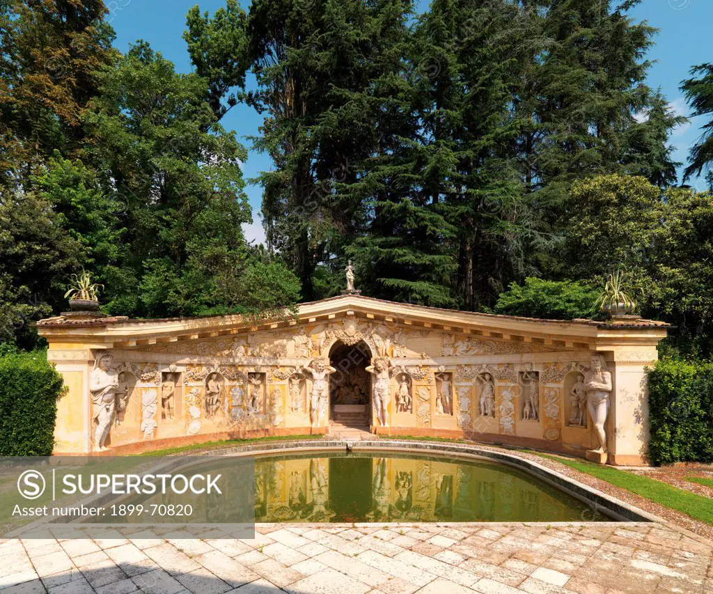 Italy, Veneto, Treviso, Maser, Villa Barbaro. Detail. View of the nymphaeum with the pool in the garden of the Villa; the exedra, with a tympanum pediment, has an arch in the middle and hosts niches with mythologic statues and telamones.