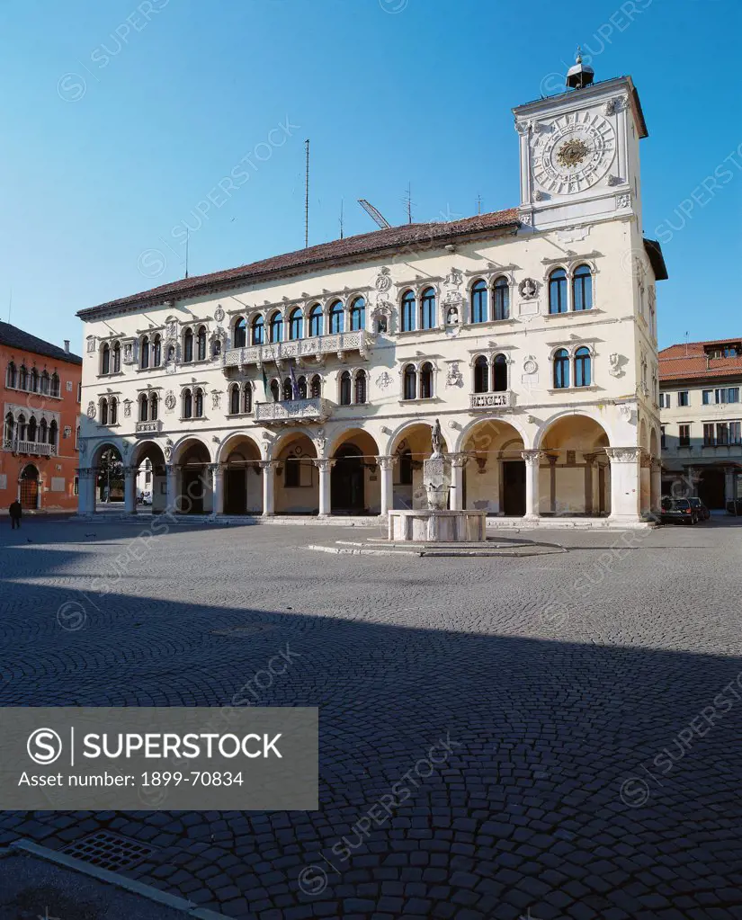Italy, Veneto, Belluno, Palace of Chancellors (Prefecure). Whole artwork view. View of the facade with elegant double lancet windows, bas-reliefs and a clock tower.