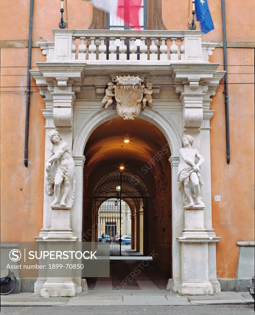 Italy, Emilia Romagna, Parma. Whole artwork view. Rangoni palace: view of the massive portal. According to the tradition of Bibiena, two statues are standing at the entry of the portal; the balustrade balcony is held by heavy corbels, but it seems it is held also by the Farnese family coat of arms (in the centre).