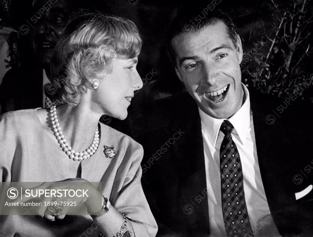 American ambassadress Clare Boothe Luce smiling with American baseball player Joe DiMaggio. 1955