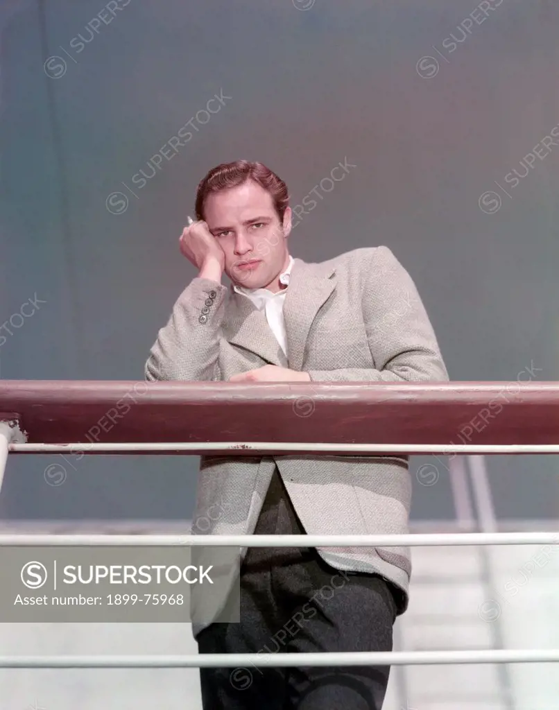 American actor Marlon Brando leaning on the parapet of a boat and posing. 1950s.