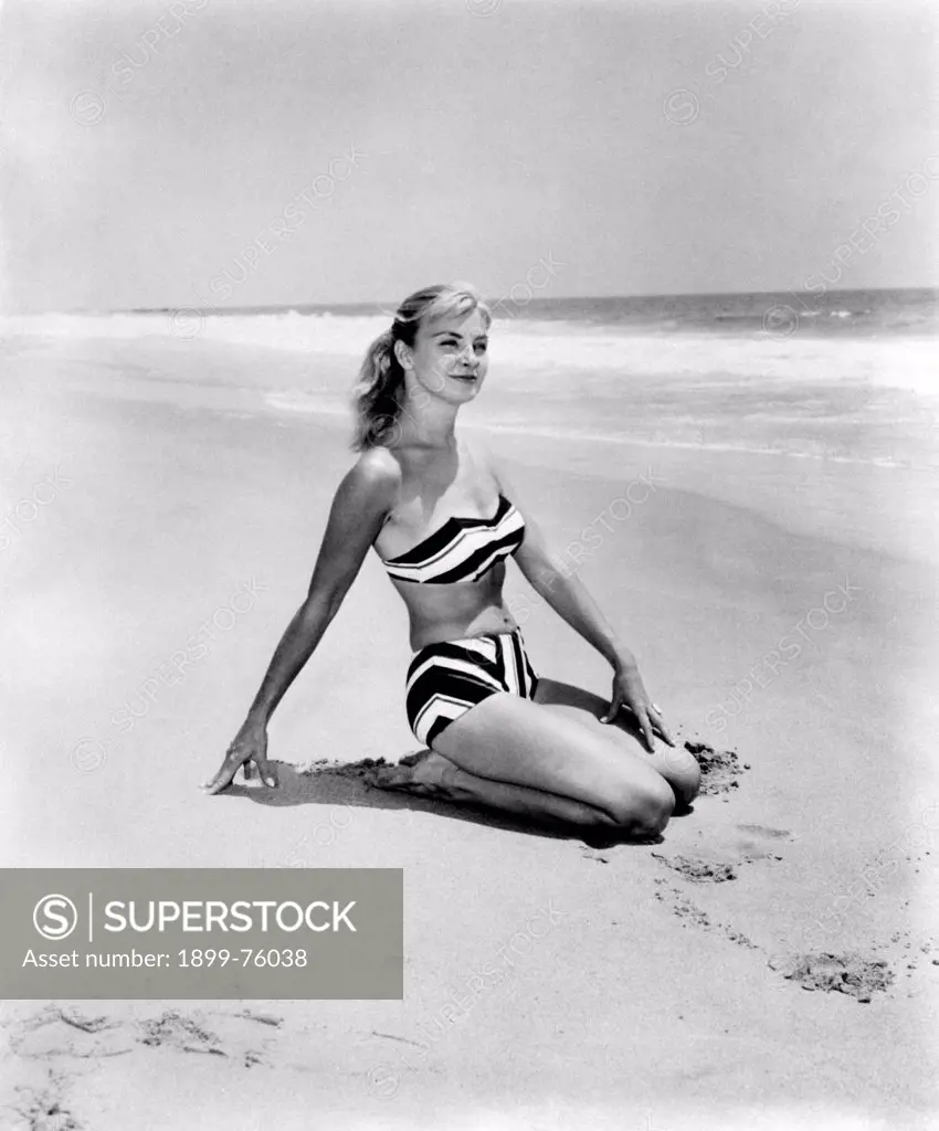 American actress and film producer Joanne Woodward (Joanne Gignilliat Trimmier Woodward) wearing a swimsuit and posing on the beach. 1950s.