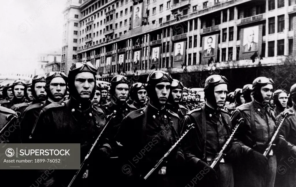 Soviet Army soldiers marching in the street. Portraits of Stalin (Ioseb Besarionis Dze Jughasvili), Nikita Krusciov, Kliment Efremovic Vorosilov and Vjaceslav Michajlovic Molotov are hanging on the faade of the building. Moscow, 1st May 1951.