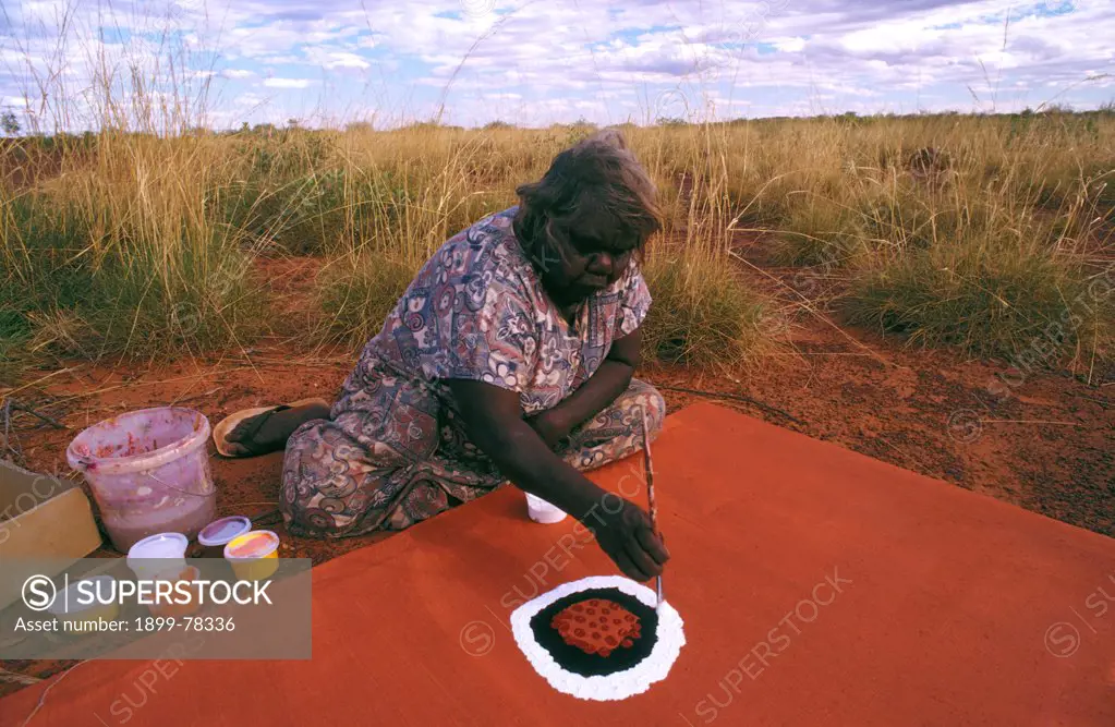 Artist beginning her painting Otjuriltjarra Balgo Wirrimanu, southeast Kimberley region, Western Australia