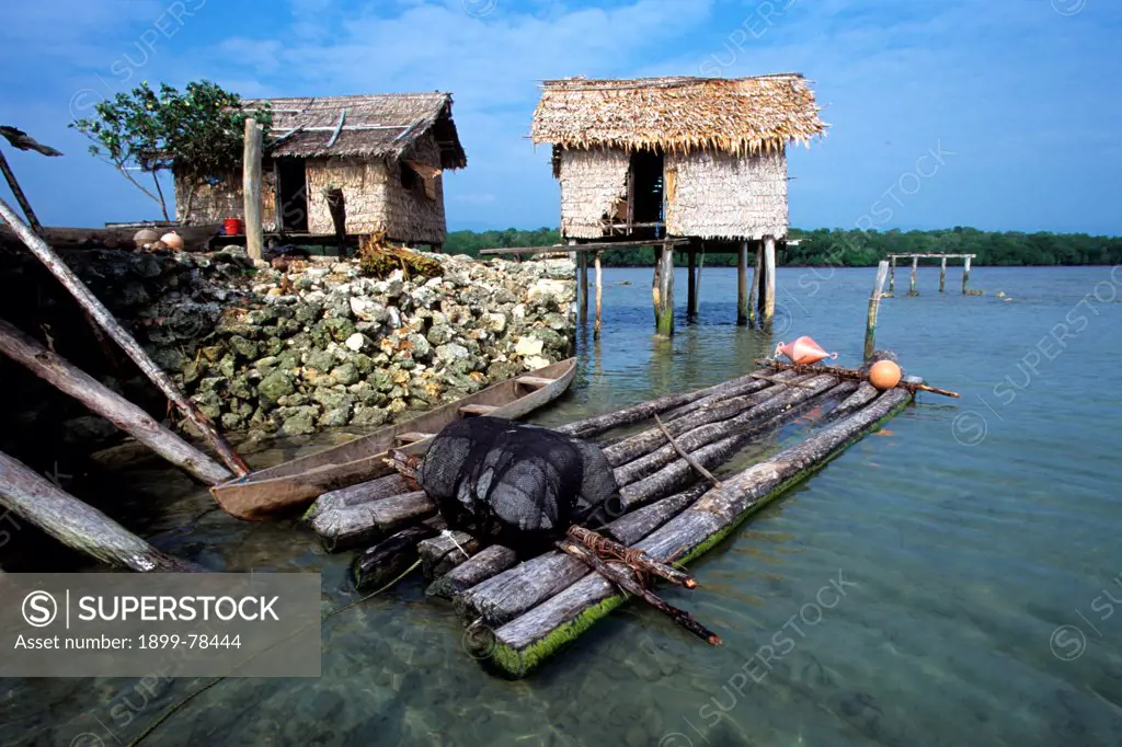 Village houses built on man-made islands formed by mining and piling up coral from the surrounding coral reef, Solomon Islands