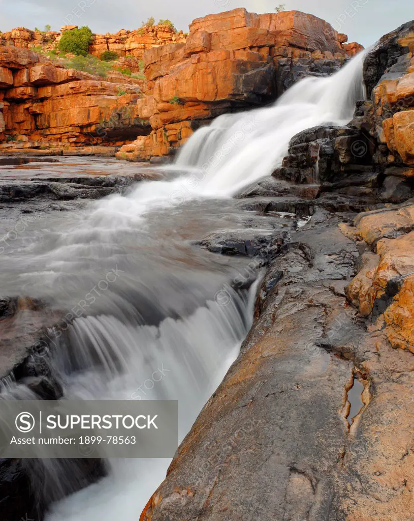 Wet season waterfall on Cowandyne Creek in its deeply incised gorge, King Leopold Ranges,Mornington Wildlife Sanctuary, central Kimberley, Western Australia