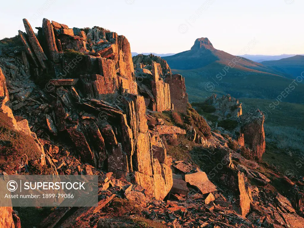 Barn Bluff, the States fifth-highest mountain from Cradle Mountain at sunset, with dolerite rock formations in the foreground, Cradle Mountain-Lake St Clair National Park, Tasmania, Australia