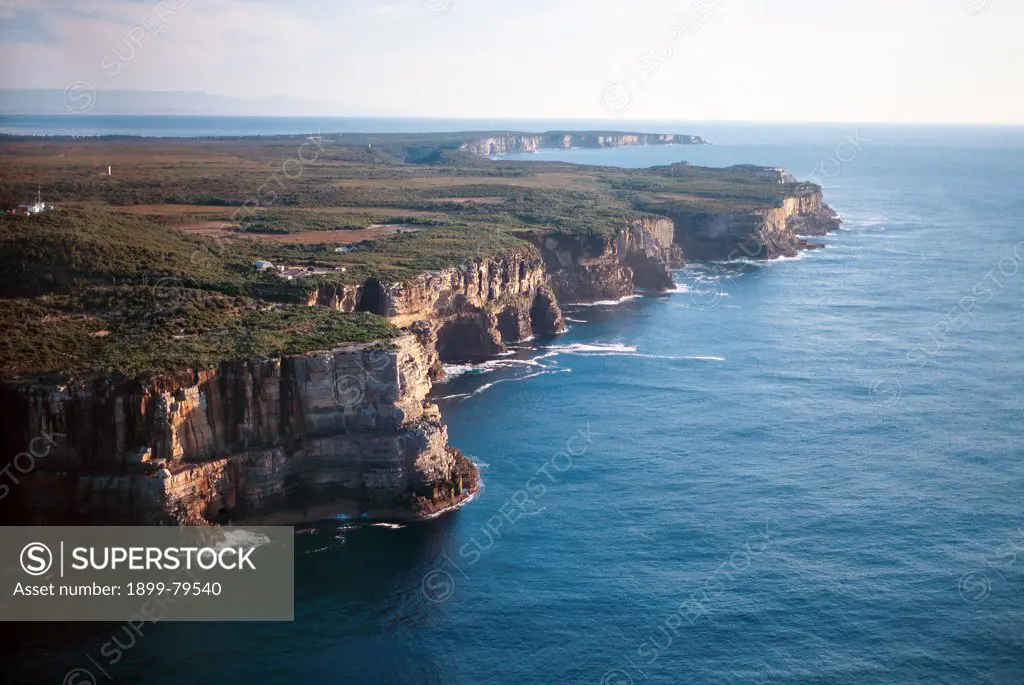 Aerial view of Crocodile Head on Beecroft Peninsula with rugged coastline and steep cliffs, Jervis Bay National Park, New South Wales, Australia