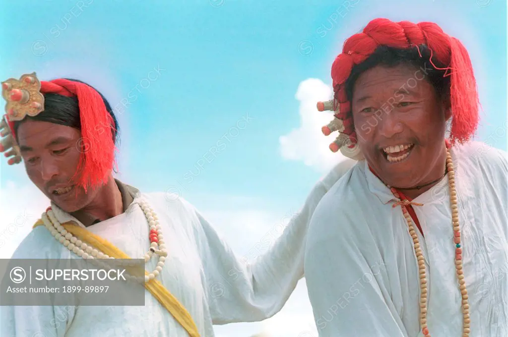 Two Tibetan dancers performing a traditional dance at the annual horserace festival, Litang, Sichuan province, China. Aug 2003