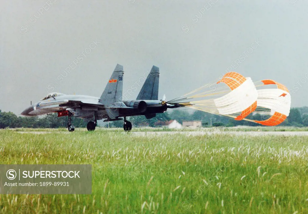 A Russian-made SU-27 fighter jet,the latest addition to the Chinese Air Force, landing on the runway. China. 1998. This jet is also produced in China from kits as the Shenyang J-11.