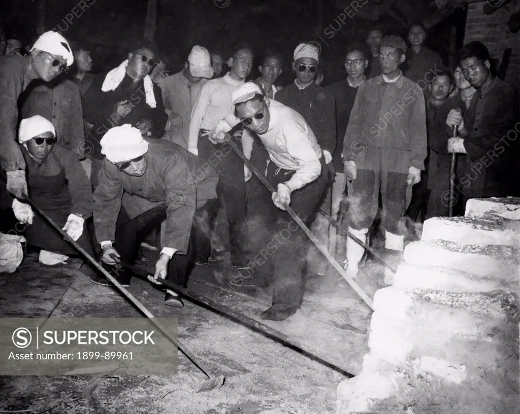 Peng Hsiao-chien, deputy governor of Hunan province, smelting steel in steel works run by provincial government. China. December 1958. Great Leap Forward. Steel production drive.