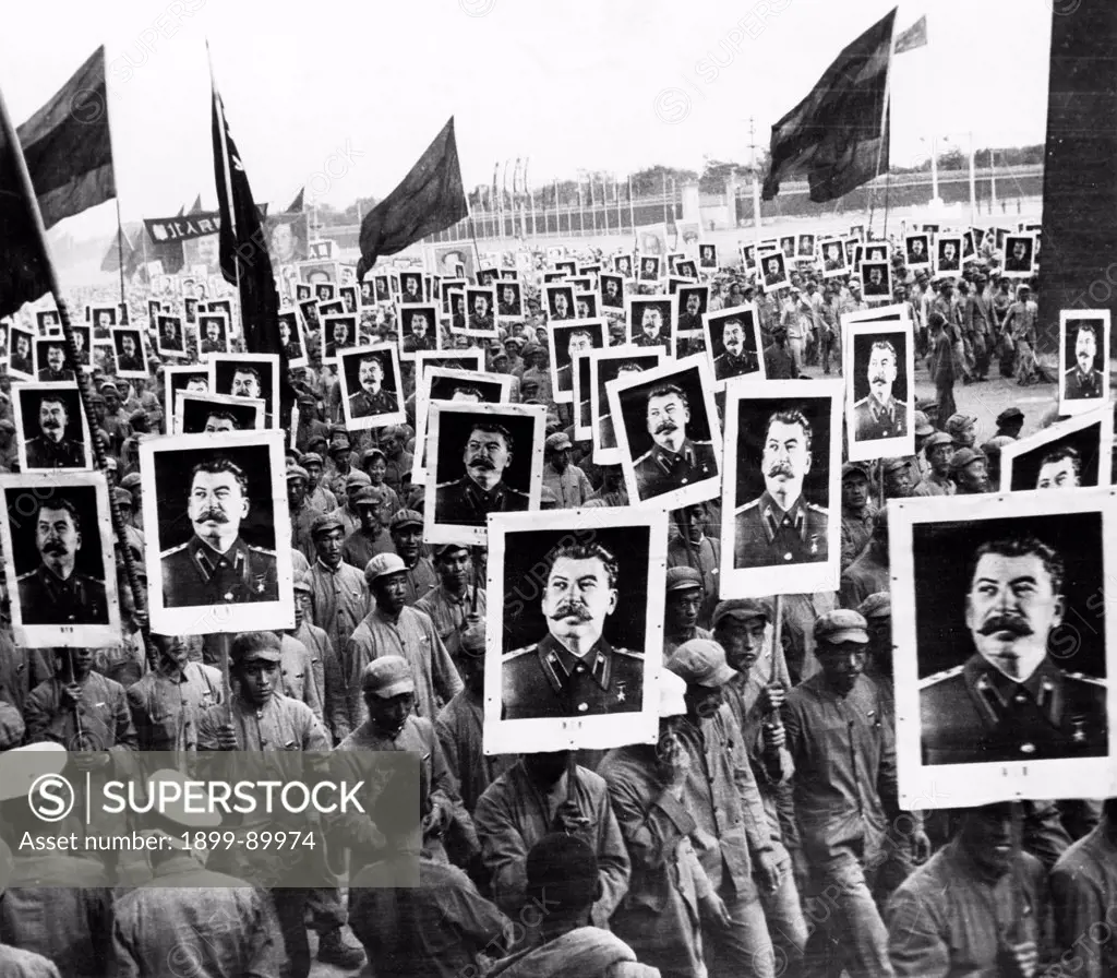 The Chinese People's Republic celebrating its first anniversary, November 1950. Many of the 500,000 participants in the demonstration are holding placards bearing Stalin's likeness.