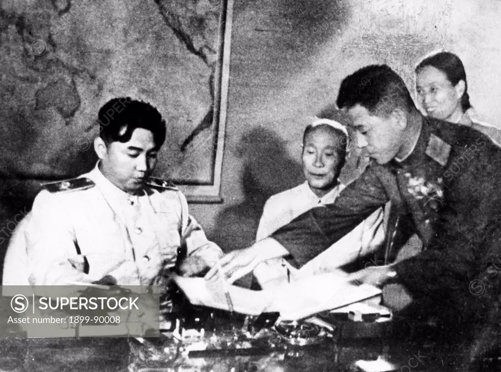Marshal Kim Il Sung signing the Korean Armistice Agreement and the Temporary Agreement Supplementary to the Armistice Agreement at 10pm on July 27, 1953. Also pictured are (l to r); Kim Du Bong, President of the Standing Committee of the Korean Supreme People's Assembly; General Nam Il; and Bak Cheng Ai, Secretary of the Central Committee of the Korean Nodong Dang.