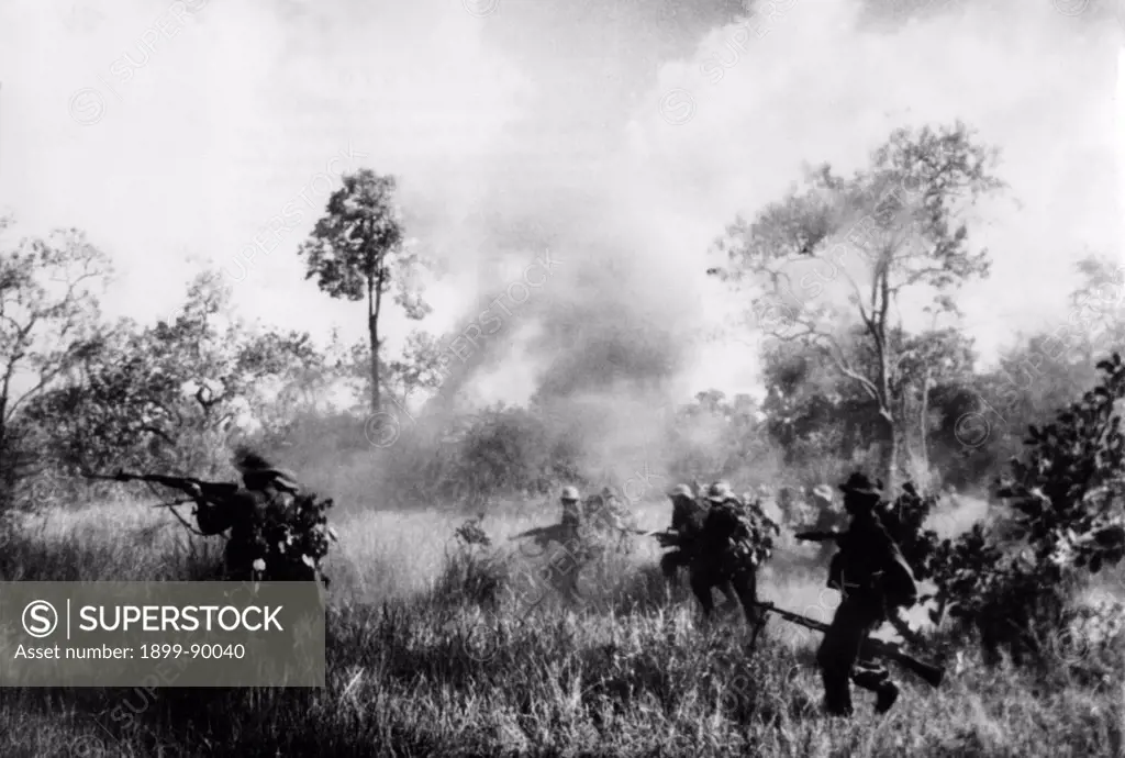 Soldiers of South Vietnamese Liberation Army (NFL) advance into battle against US forces. Vietnam, 1966. Vietnam War.
