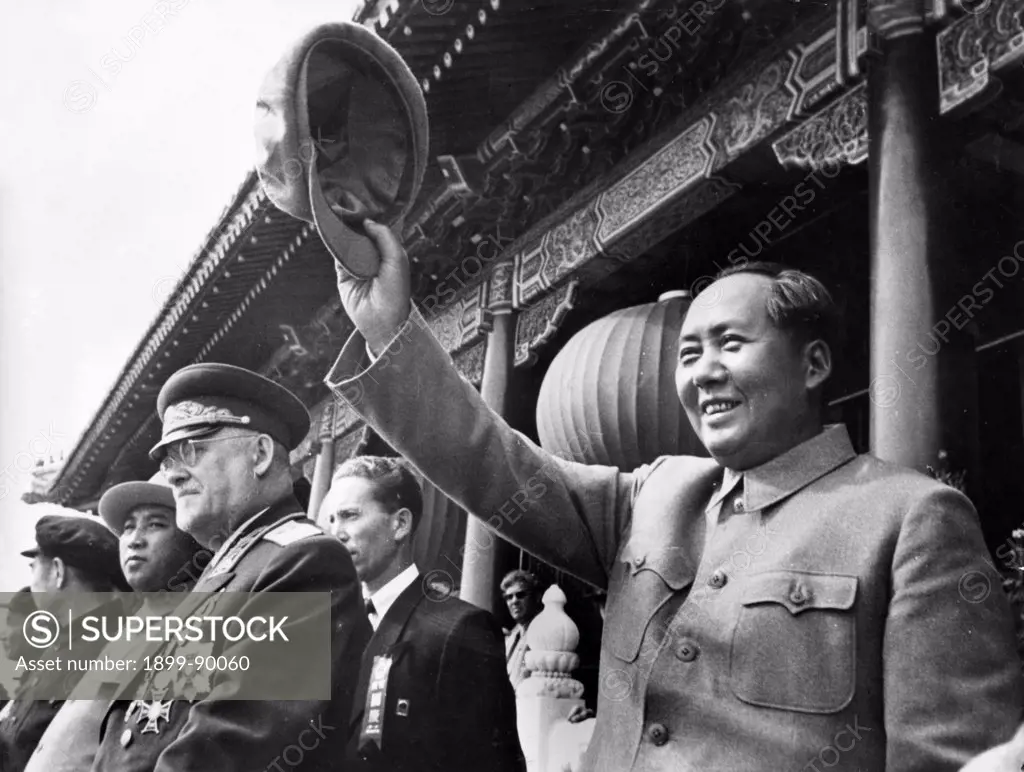 National Day celebration in Beijing, October 1, 1954. Mao Zedong waving to paraders from the rostrum in Tien An Men Square. To his right are N. Bulganin, Kim Il Sung, and Chou Enlai (head turned).
