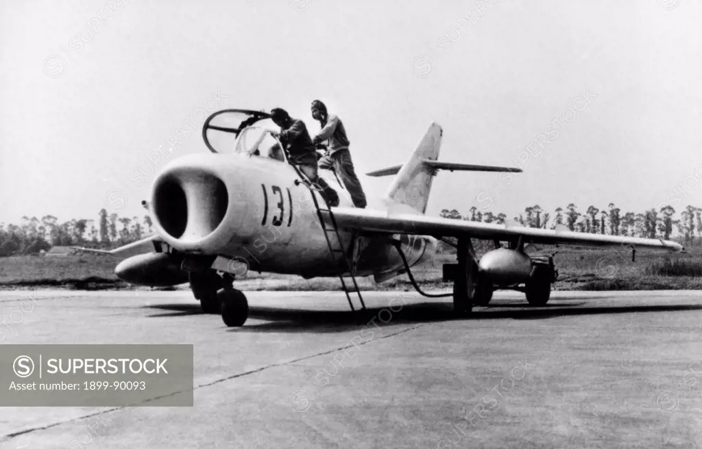 Chinese Air Force pilots preparing for a flight aboard a Chengdu JJ-5, an advanced training version of the J-5 (MiG-17) interceptor. 1985.