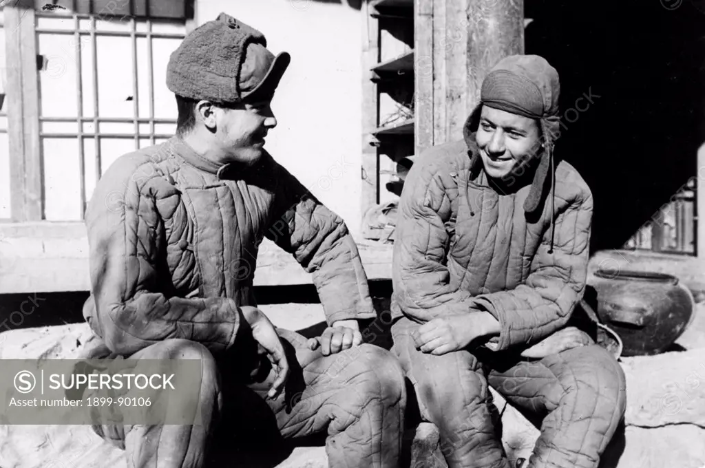 Korean War. 'These two American POW's dressed in the warm cotton-padded clothing given to them by the Chinese People's Volunteers are Johnnie Wilson Moore, Co. B, 35th Infantry Regiment, 25th Div. of the 8th Army, address P.O. Box 1339, Mac Farland, CA and Willis J. Nichols Jr, Co. K, 8th Cavalry Regiment, 1st Cavalry Div, address 621 Fitch Street, Oneida, NY.'