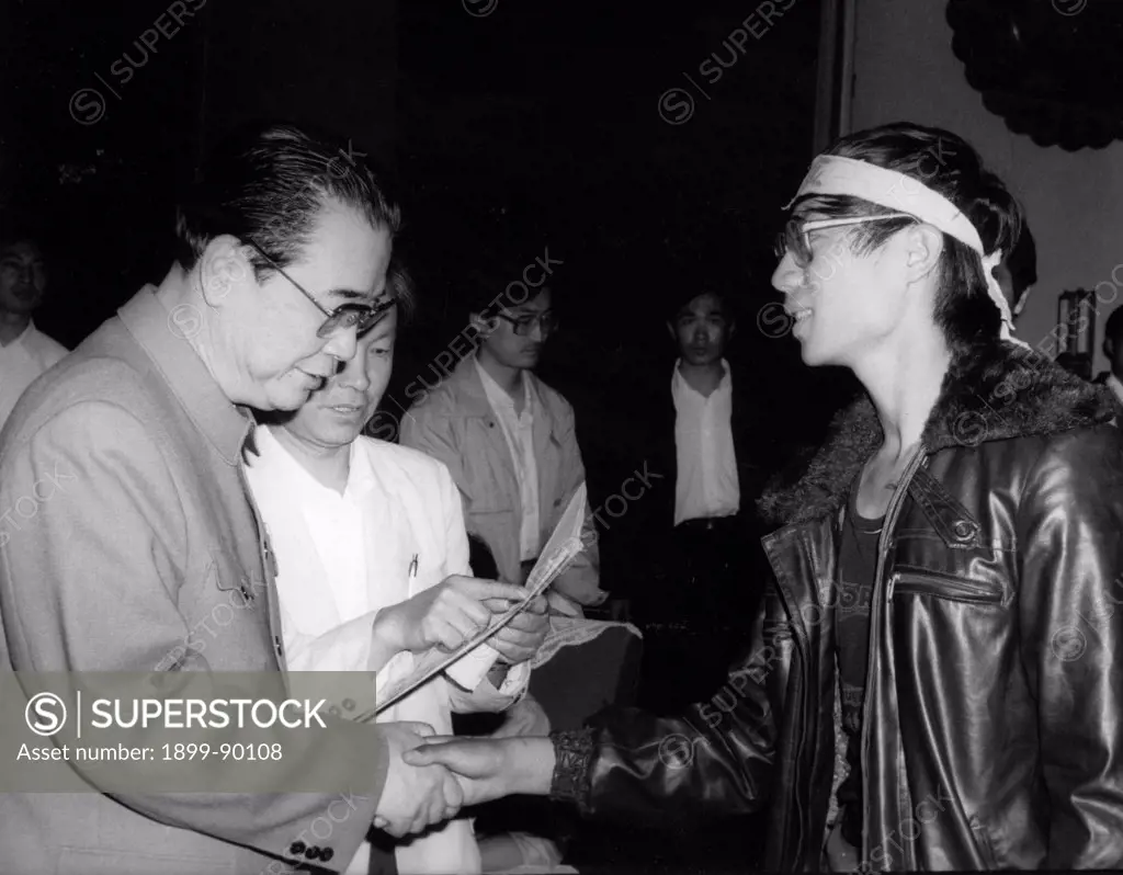 Chinese premier Li Peng (left) shakes hands with Wang Dan, representative of Beijing University pro-democracy hunger strikers. May 1989. Beijing, China.