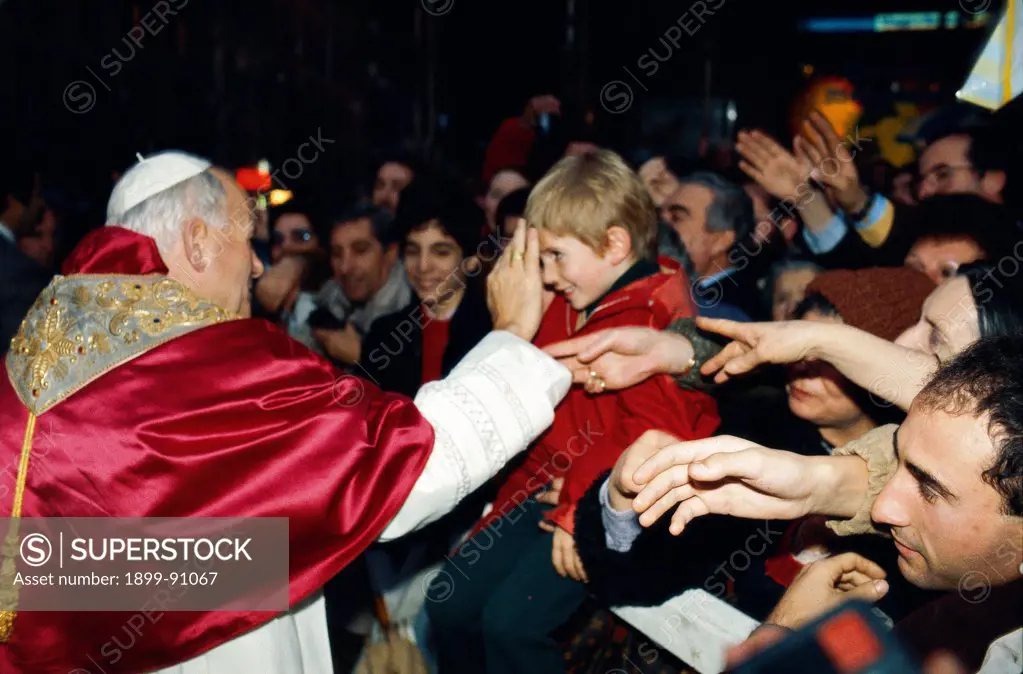 Pope John Paul II is blessing a boy in the crowd acclaiming him in Piazza di Spagna. Rome (Italy), December 8, 1982.