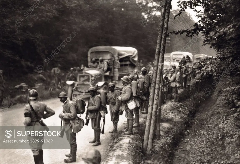 German troops are drawn up in the street at the passage of a convoy of military motor vehicle during World War I. 1910s